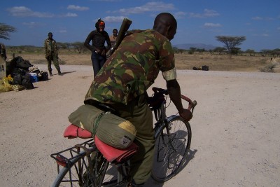 An army guy in Kenya riding my bicycle