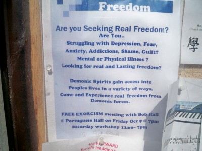 A poster advertising exorcism services seen when Cycling from Standish Hickey to Mackericher - Pacific Coast Highway Tour
