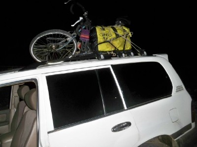My bicycle and trailer strapped to the roof of a 4WD in Panama
