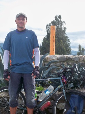 Dave Briggs with bicycle at the equator in Ecuador