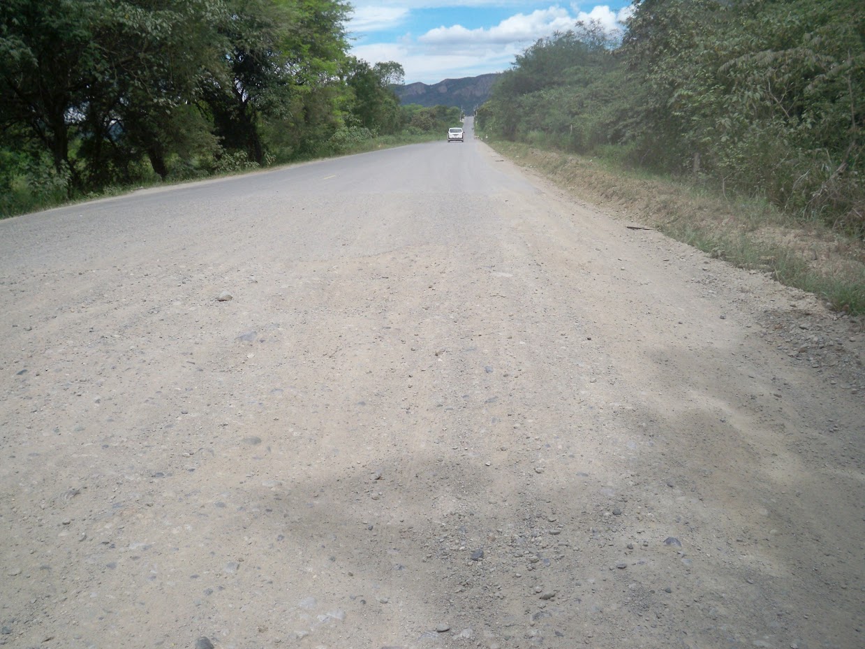 Cycling off the unsealed road and onto tarmac in Peru