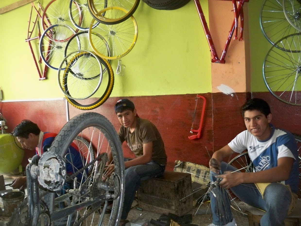 Bicycle mechanics in a bike shop in Huanuco in Peru