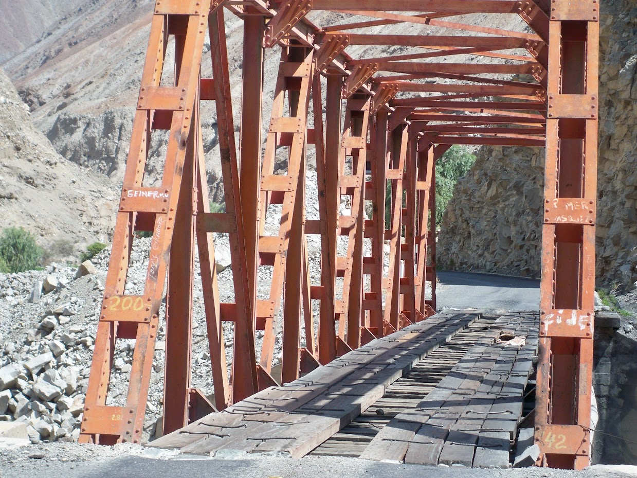 Crossing a bridge by bicycle in peru