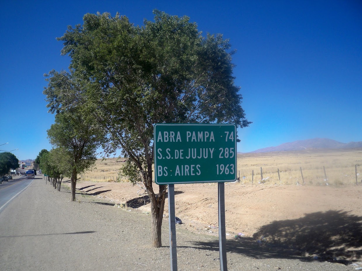 Cycling past a signpost in argentina
