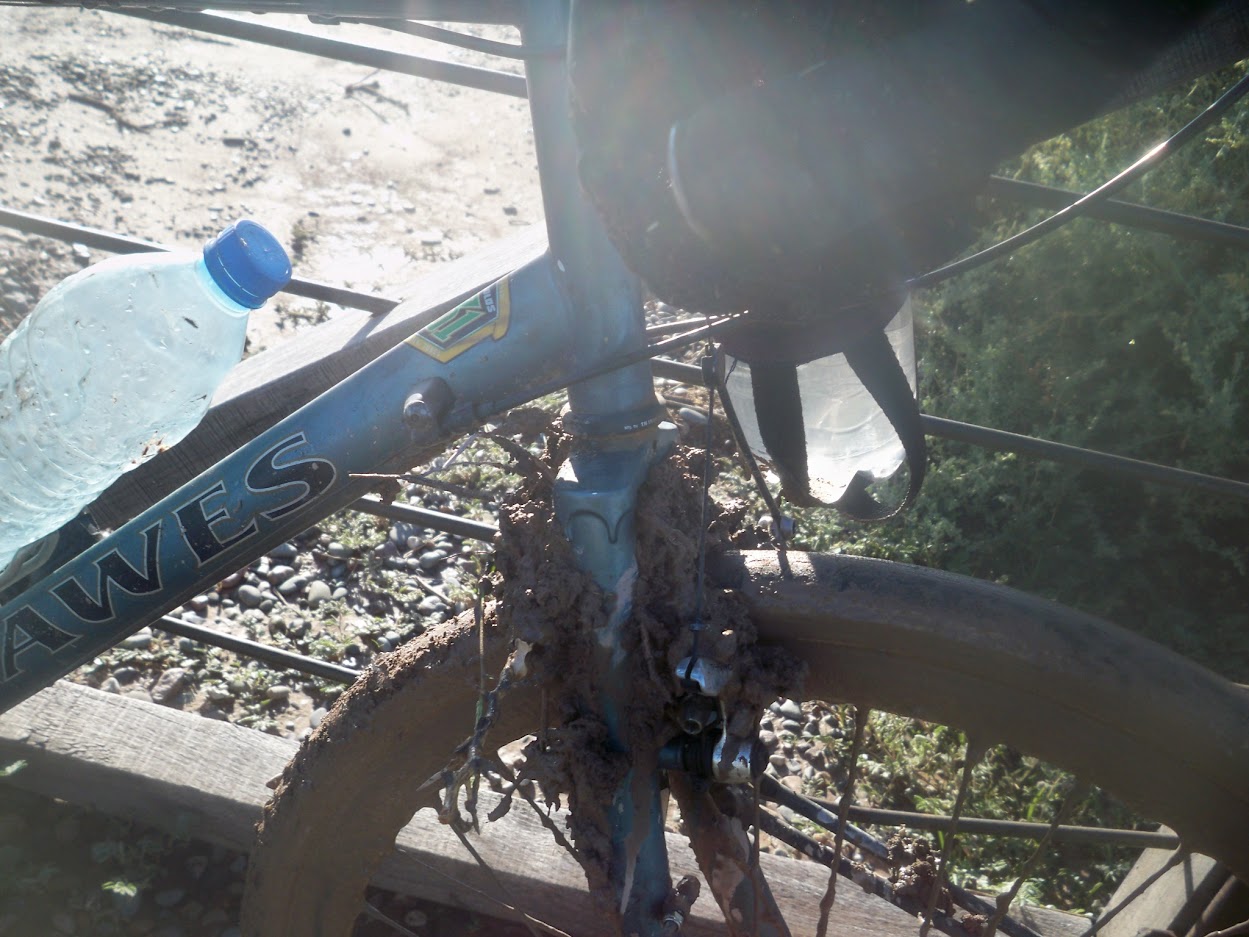 The front wheel of my Dawes Sardar touring bike covered in mud