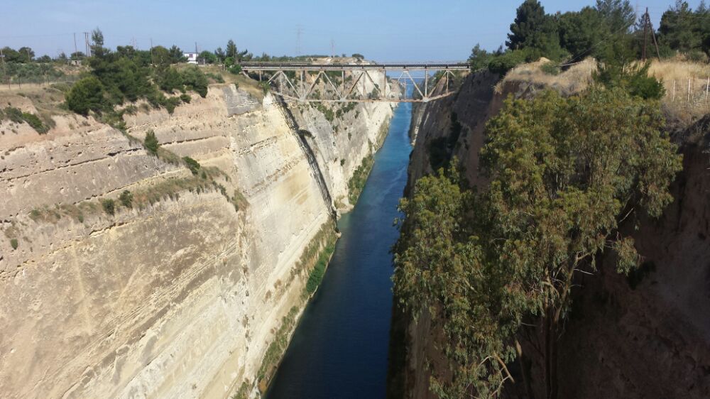 Corinth Canal separates the Peloponnese from mainland Greece. You'll cross it when visiting Mycenae on a day trip from Athens.