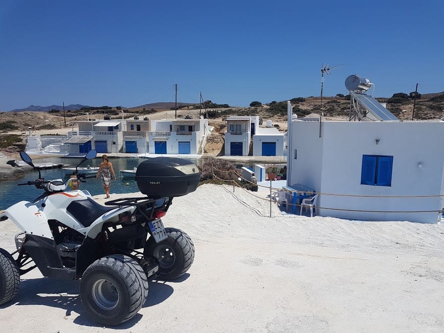 A quad bike parked outside a small coastal village in Milos