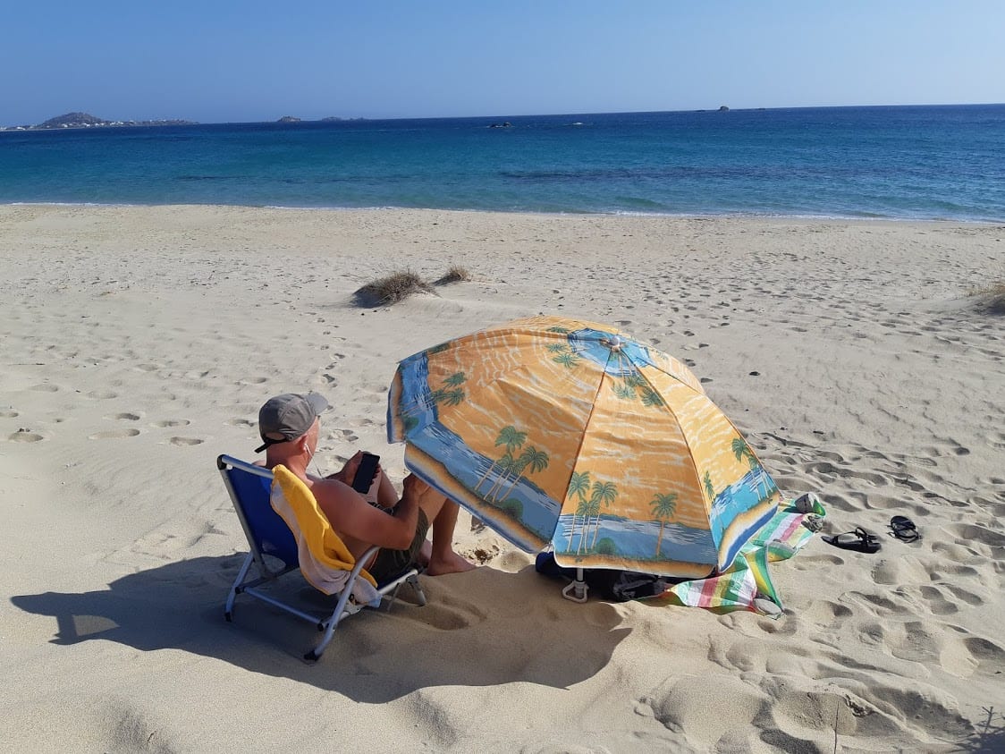 Dave from Dave's Travel Pages relaxing on a beach in Naxos Greece