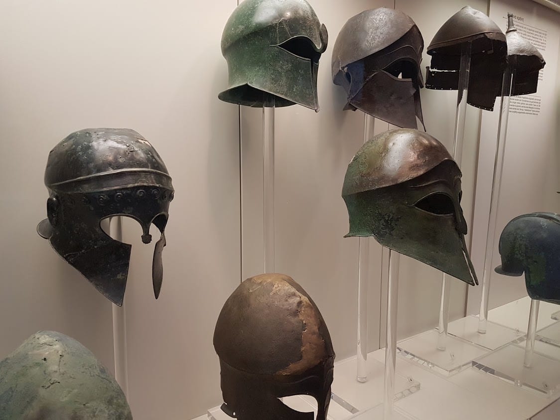 A collection of battle helmets from ancient Greece on display in Olympia