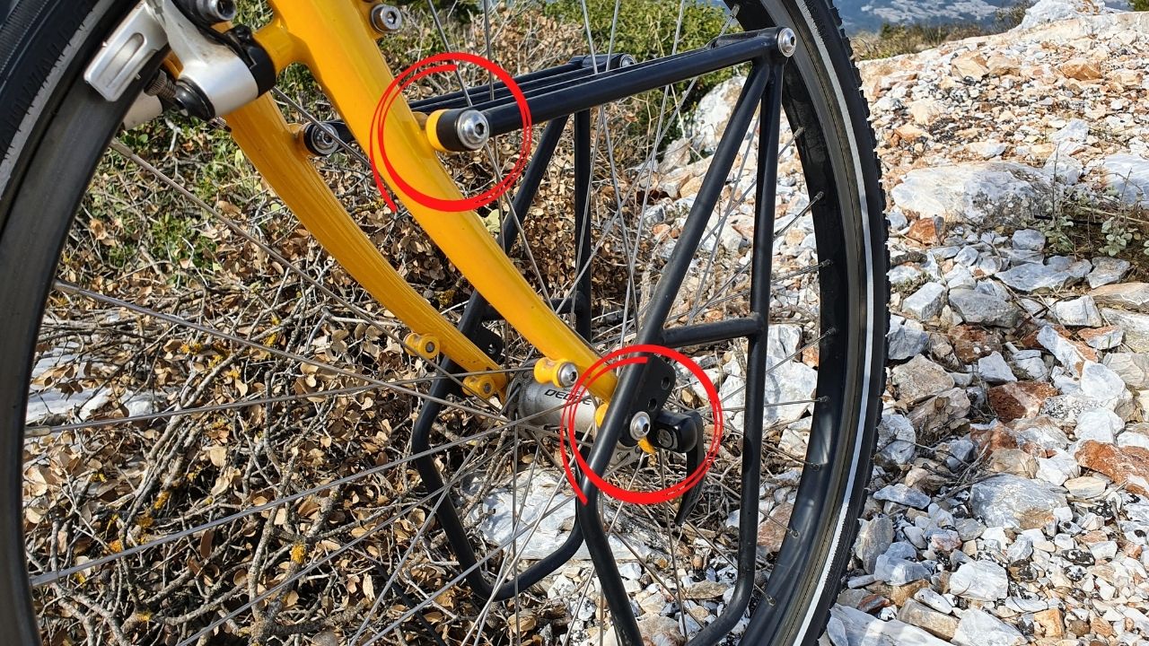 The eyelets on a touring bike circled in red - this is where you attach a front rack