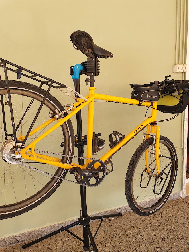 A Thorn Nomad Expedition Bicycle attached to a bike repair stand using the clamping mechanism on the seatpost