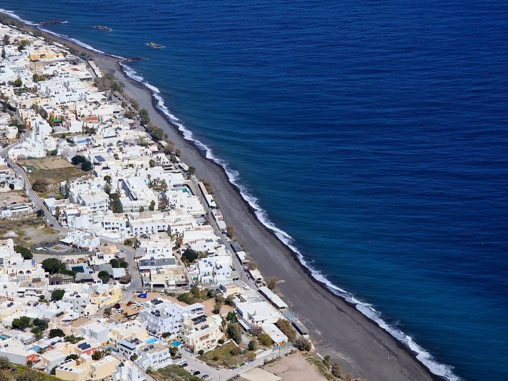 View of Kamari black sand beach as seen from the hiking trail from Kamari to Ancient Thera