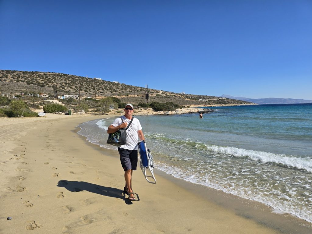 Travel blogger Dave Briggs walking along a beach in Greece
