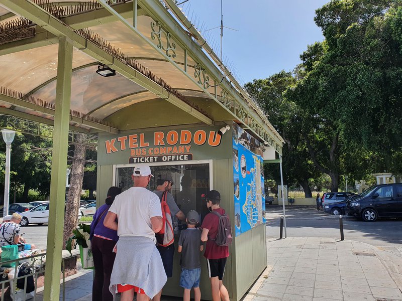 Tourists queue at the KTEL Rodou (Rhodes) bus company ticket office to purchase tickets.